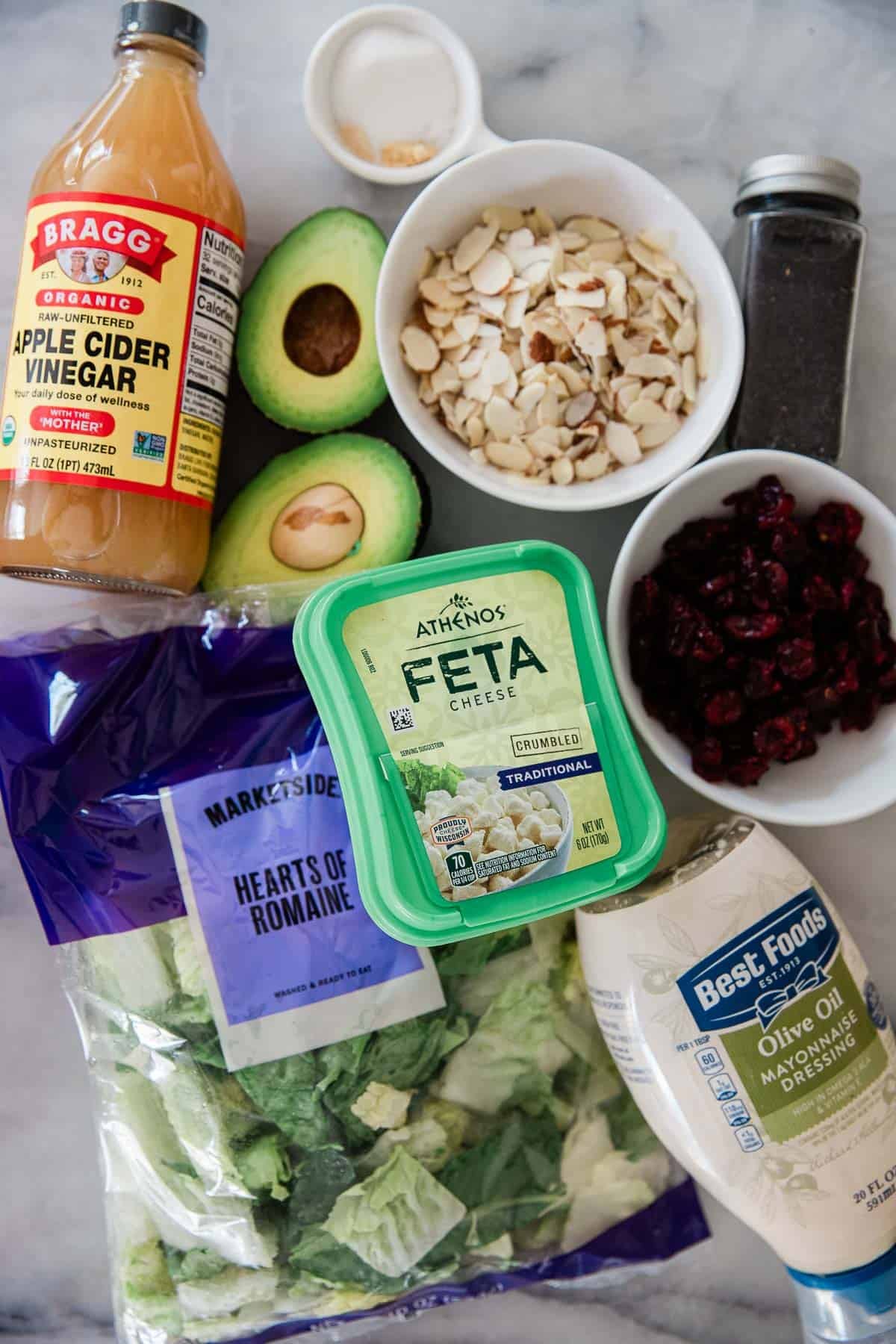 Ingredients to make this avocado and lettuce salad on a table.