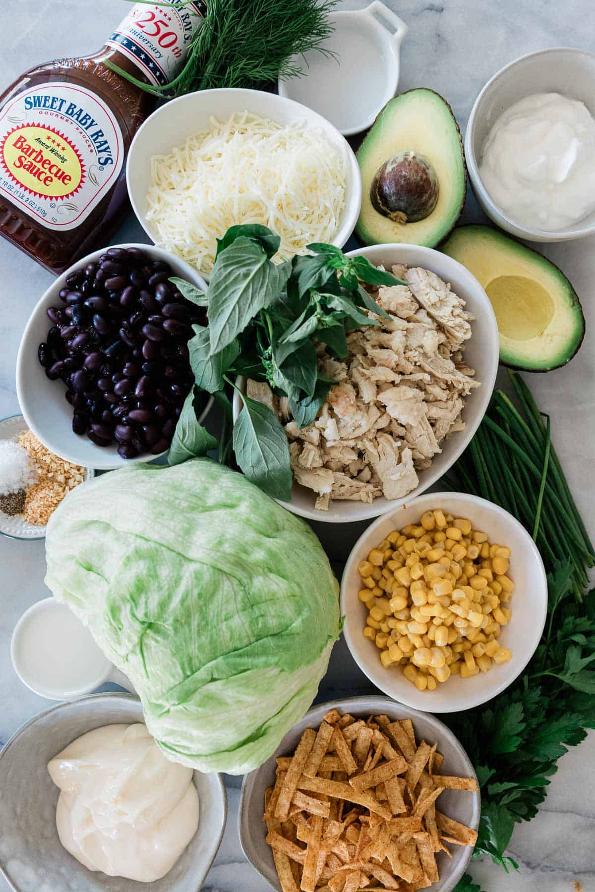 Ingredients to make this BBQ chicken salad on a table.
